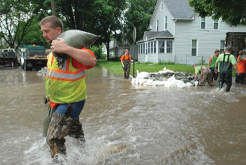 Responders working to hold back flooding with sandbags