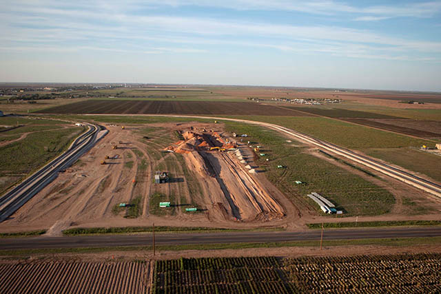 Workers construct new rail spur to facilitate shipping raw materials to manufacturing and distribution center.
