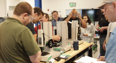 Photo of students are competing in teams to procure a contract with a wind turbine manufacturing firm.