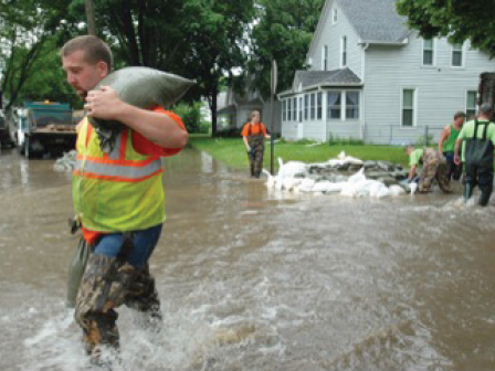 Responders working to hold back flooding with sandbags